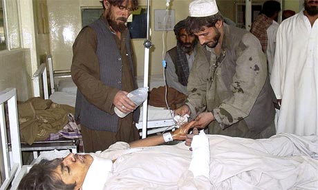 Family attend to a man injured by the earthquake, at a hospital in Quetta, Pakistan