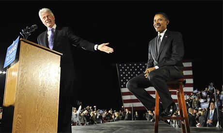 Barack Obama sits beside the former US president Bill Clinton during a midnight rally in Osceola Heritage Park in Kissimmee, Florida
