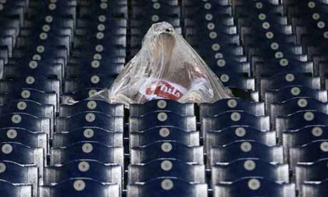 Baseball's World Series fan sits in stands in rain