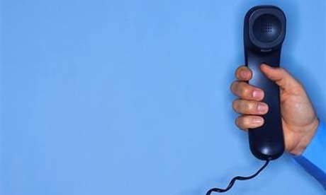 Hand holding telephone receiver