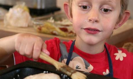 Andrew, 6, covers breadrolls with oil