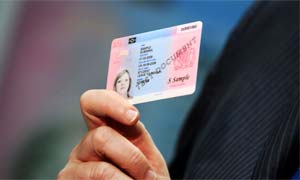 Jacqui Smith holds a sample British identity card