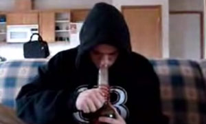 A young man smoking Salvia - a 'legal high'