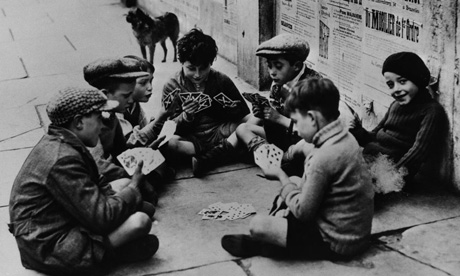 Homeless children play a card game in Paris during the second world war.