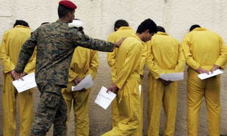 A guard escorts suspected terrorists at the police headquarters in Baghdad, 2008. Photograph: Karim Kadim/AP