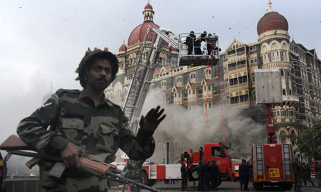 An Indian soldier prevents people from aproaching the Taj Mahal hotel after the rescue operation