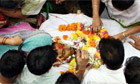 Relatives grieve over the body of Harish Gohil during a funeral possession in Mumbai