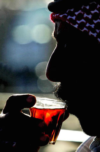 Gallery December 1 2008: Sahab, Jordan: A shepherd takes a tea break at an animal market