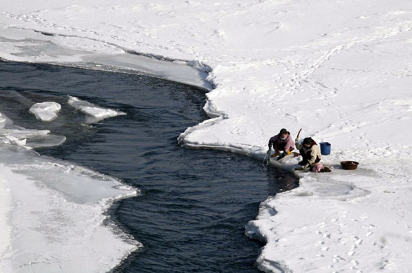 Gallery December 1 2008: North Korea: People wash their laundry at the Yalu river