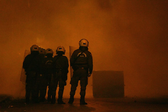 Gallery Greek riots: Riot police stand amidst tear gas