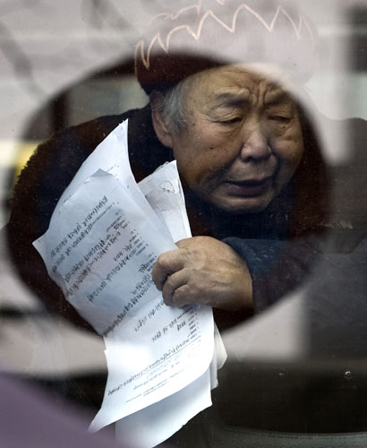 Gallery December 10 2008: Beijing, China: A petitioner looks out from the window