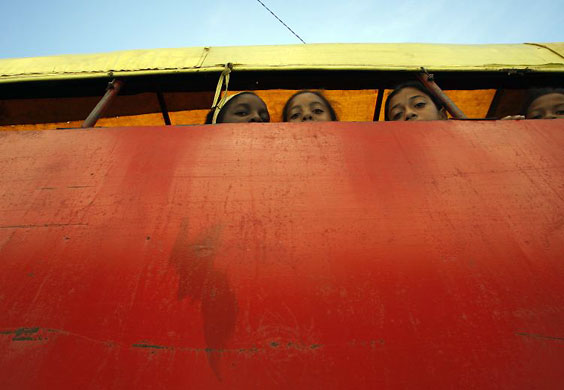 Gallery December 10 2008: Cuba: Children sit on a truck used for public transportation