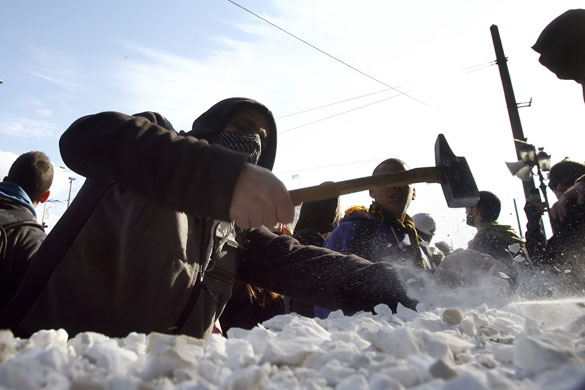 Gallery Greek Riots Continue: A protester smashes marble slabs
