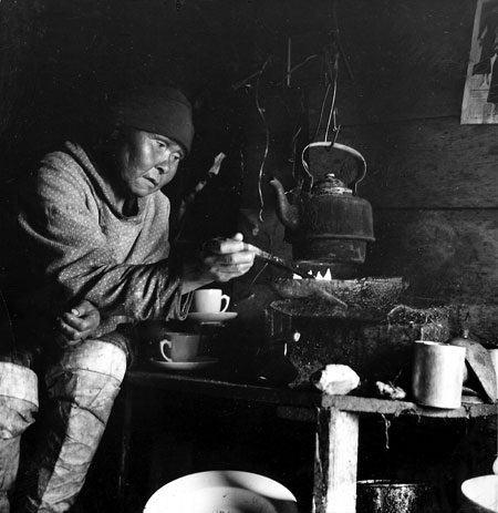 Gallery Greenland: A woman cooking in her family hut in Greenland