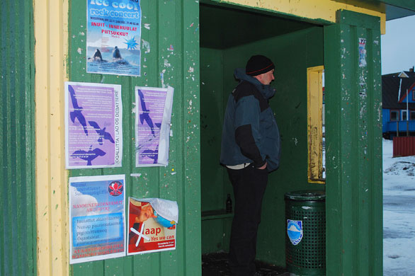 Gallery Greenland: A man stands in a bus shelter in downtown Nuuk, the capital of Greenland