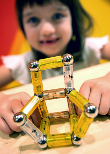 Gallery Children's toys: A girl plays with an Electro Mag toy