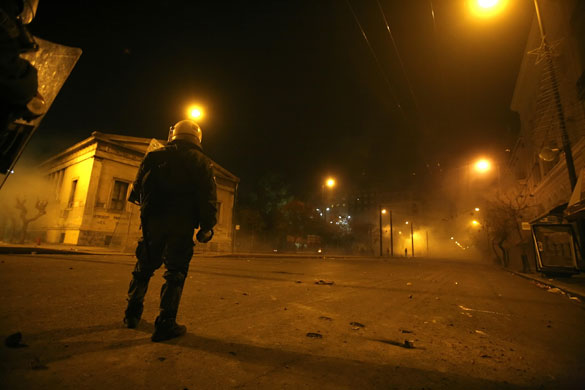 Gallery Greece riots: A riot police officer stands outside Athens Polytechnic