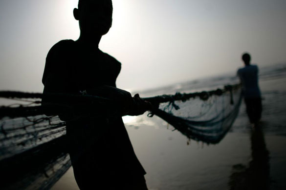 Gallery December 12 2008: Accra, Ghana: Fishermen work together to haul in a net