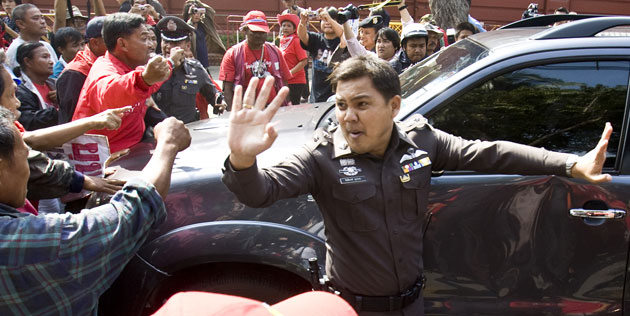 Thailand: A policeman attempts to block pro Thaksin Shinawatra supporters