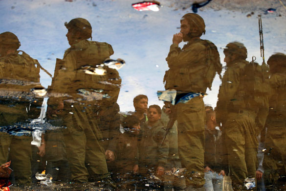Gallery 16 December 2008: Israeli soldiers stand guard in front of Palestinians near Ramallah