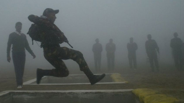 Gallery 17 December 1008: Lucknow, India: A soldier jumps across a hurdle during a training period