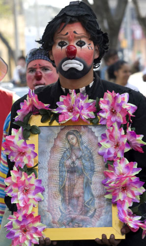 Gallery 24 hours in pictures : Clown holds picture of Virgin of Guadalupe during annual pilgrimage  