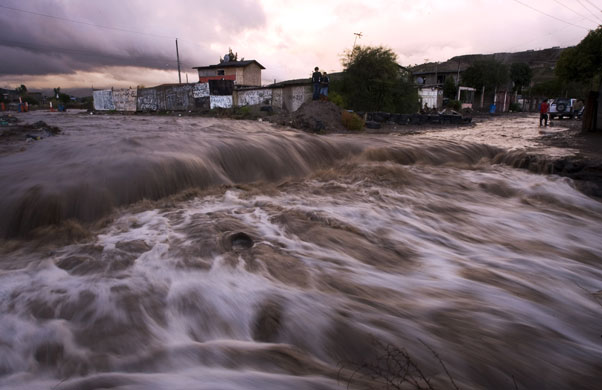 Gallery 24 hours in pictures : A flooded street is seen in a poor neighborhood of Tijuana, Mexico