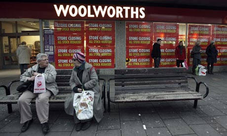 Shoppers sit outside a Woolworths branch in London