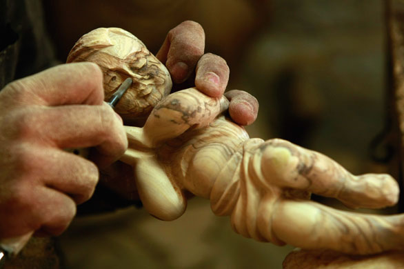 Gallery 19 December 2008: Bethlehem, West Bank: Craftsman Adel Daroud carves an effigy of  Jesus