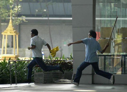 Gallery Thai politics: A demonstrator chases a suspected government supporter 