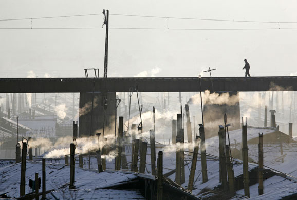 Gallery 24 hours in pictures : A North Korean man walks on a railway bridge in Hyesan