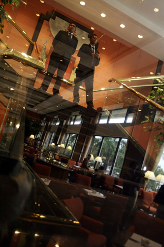 Gallery Mumbai hotels reopen: Security personnel stand guard in the lobby of Oberoi Trident