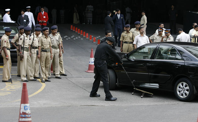 Gallery Mumbai hotels reopen: Indian police officers watch as a security guard