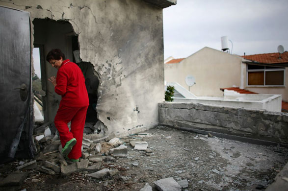 Gallery 22 December 2008: Sderot, Israel: Maya Iber inspects damage at a her destroyed house