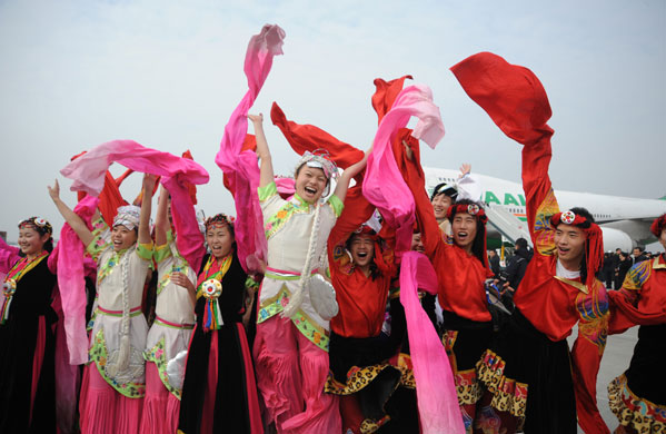 Ethic Qiang performers cheer after the farewell ceremony held for giant pandas