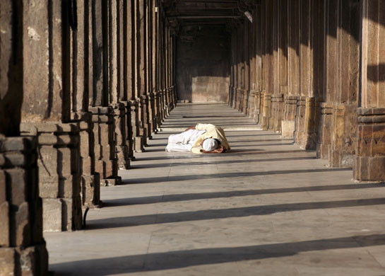 Gallery 24 hours in pictures: A Muslim man rests inside mosque in Ahmedabad