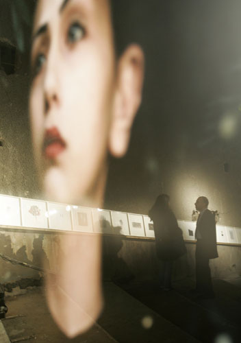 Gallery 24 hours in pictures: Visitors are reflected on one of pictures of Lebanese artist Issa 