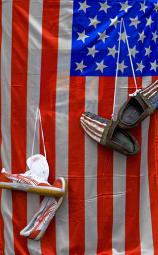 Gallery 24 hours in pictures: 24 hours in pictures : Shoes are hung in front of U.S. flag in Tehran