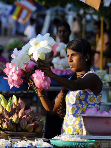 Gallery 24 hours in pictures: 24 hours in pictures: A vendor sells flowers outside The Murugan temple