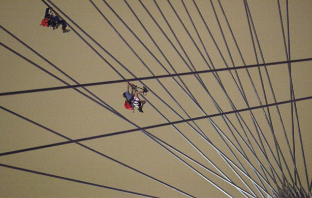 Gallery 24 hours in pictures: 24 hours in pictures: Rescue workers climb the spokes of Singapore Flyer