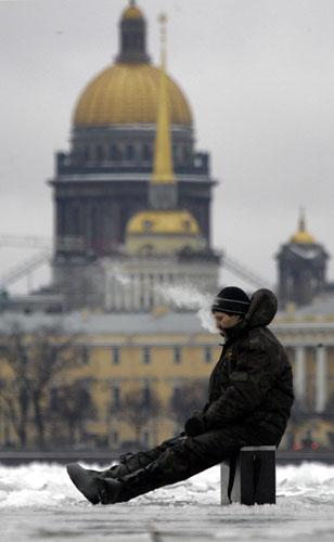 Gallery 24 hours in pictures: A fisherman smokes in St Petersburg