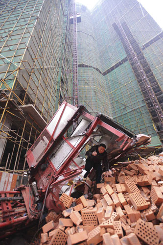 Gallery 24 hours in pictures: A rescuer at the scene of an elevator accident in China