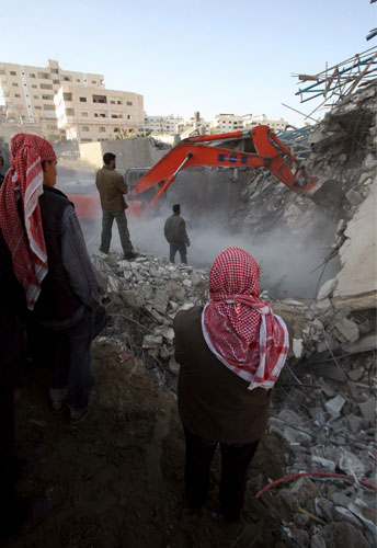 Gallery Gaza air strikes: Palestinians search for bodies in the rubble of the Hamas security compound