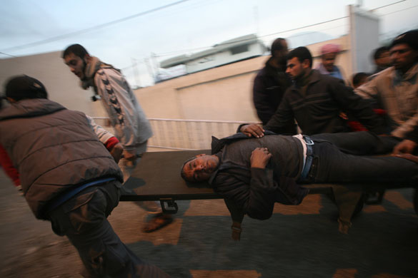 Gallery Gaza air strikes: A wounded Palestinian man is carried into a hospital in Rafah