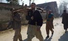 Buner, Pakistan: Men carry a man injured in a suicude bombing 