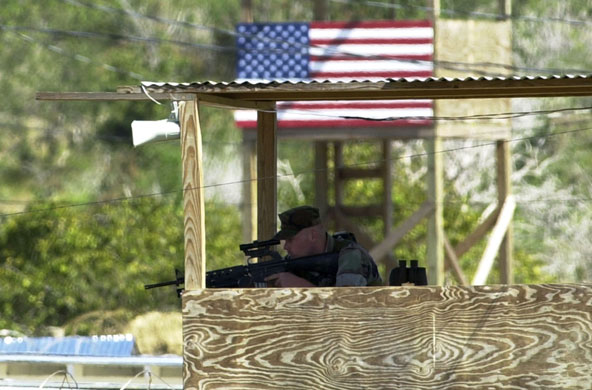 Gallery Guantanamo: A U.S. Marine keeps watch from a tower