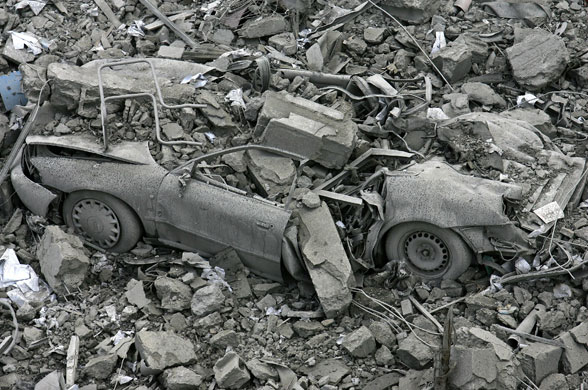 Gallery Israeli missile strikes: A car buried under rubble at the site of the ministry buildings compound