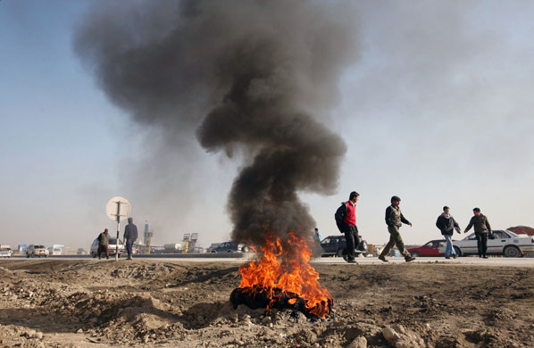 Gallery 31 December 2008: Kabul, Afghanistan: A burnt tyre during a demonstration