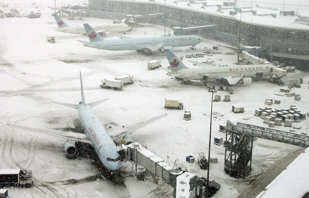 Gallery 31 December 2008: Snow-covered Air Canada planes sit at their gates at Vancouver airport