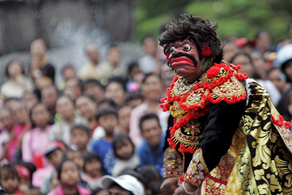 Gallery New Year's Eve: Denpasar, Bali: A mask dancer performs during a cultural parade